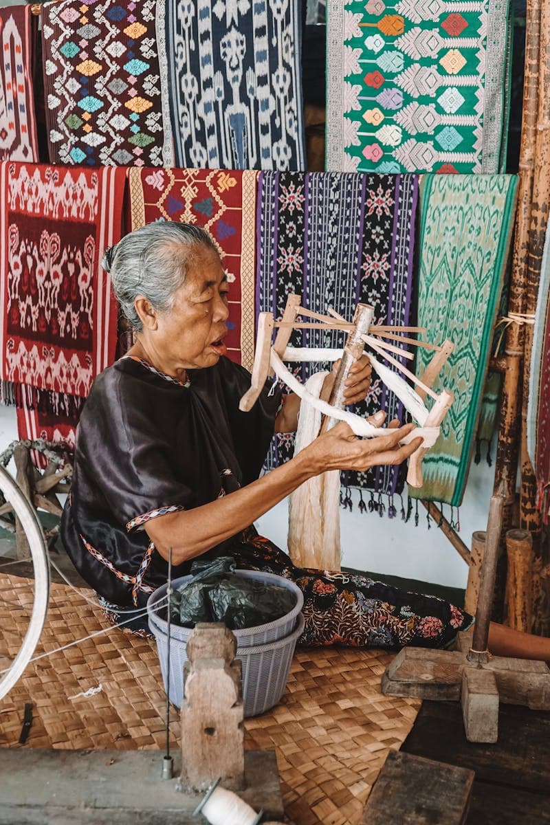 Artisan hands weaving a natural fiber basket in the Highflyer workshop